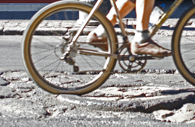 Close view of a man legs pedaling bicycle on a sunny day